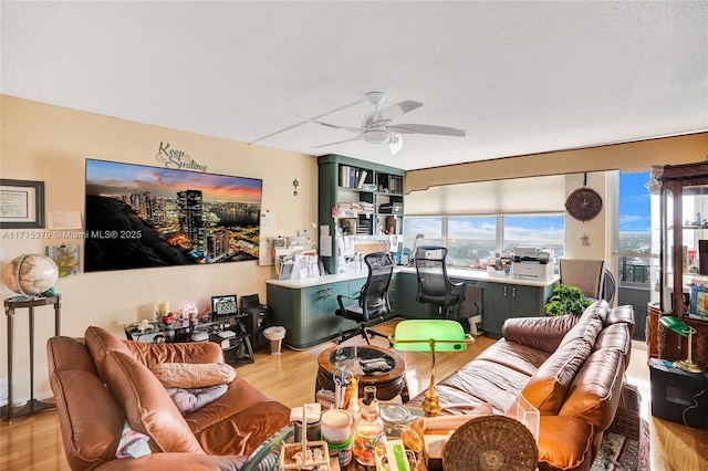 living room featuring ceiling fan and light hardwood / wood-style floors