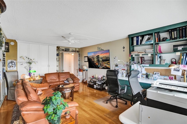 office space featuring ceiling fan, a textured ceiling, and hardwood / wood-style flooring