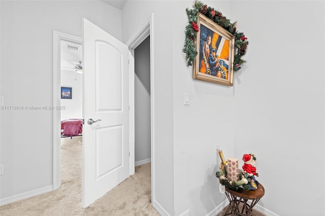 hallway featuring light carpet