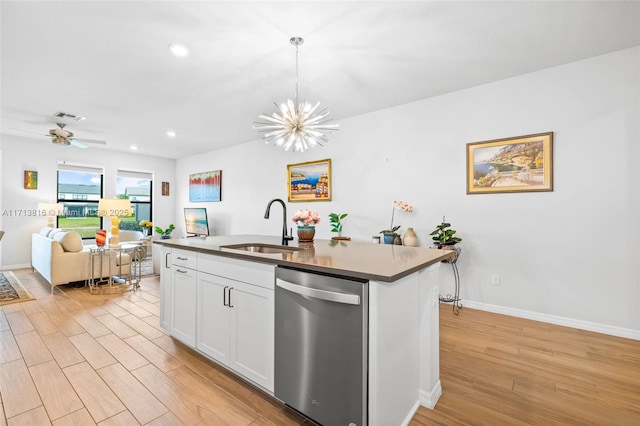 kitchen with sink, hanging light fixtures, dishwasher, an island with sink, and white cabinets