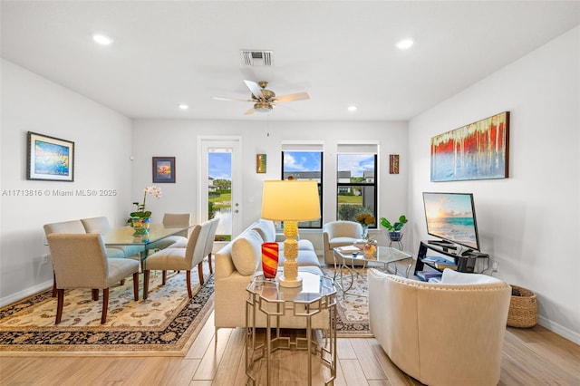 living room with ceiling fan and light wood-type flooring