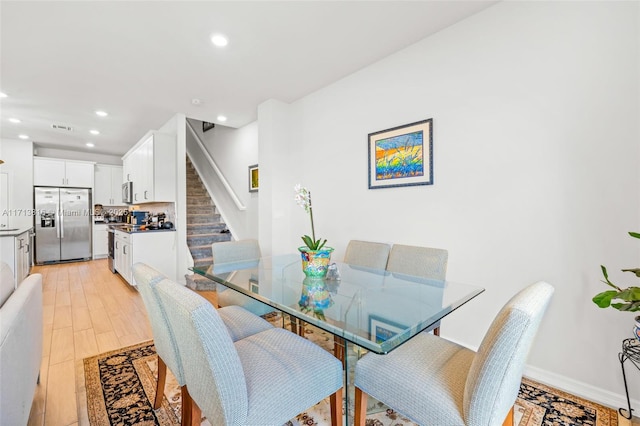 dining room featuring sink and light hardwood / wood-style floors