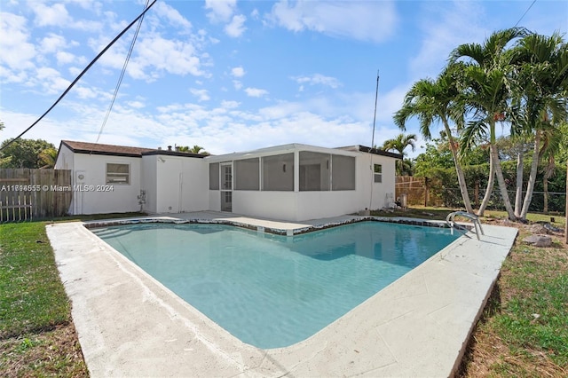 view of swimming pool with a sunroom