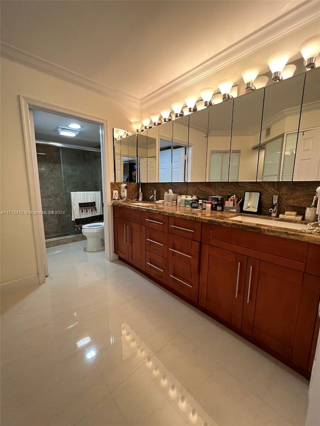 bathroom with vanity, toilet, ornamental molding, tasteful backsplash, and an enclosed shower