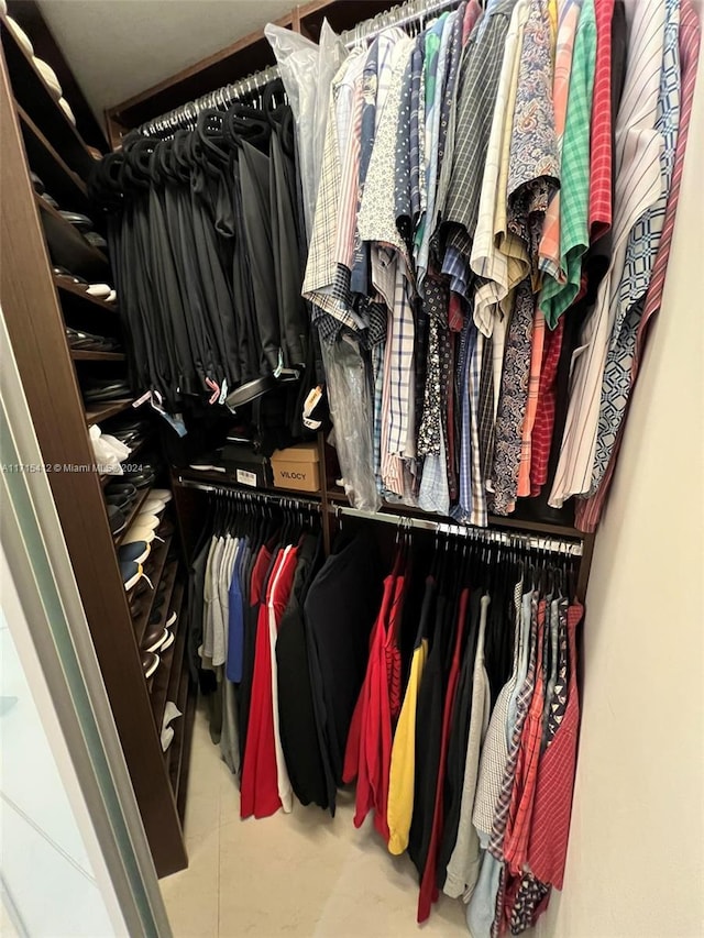 spacious closet with tile patterned floors