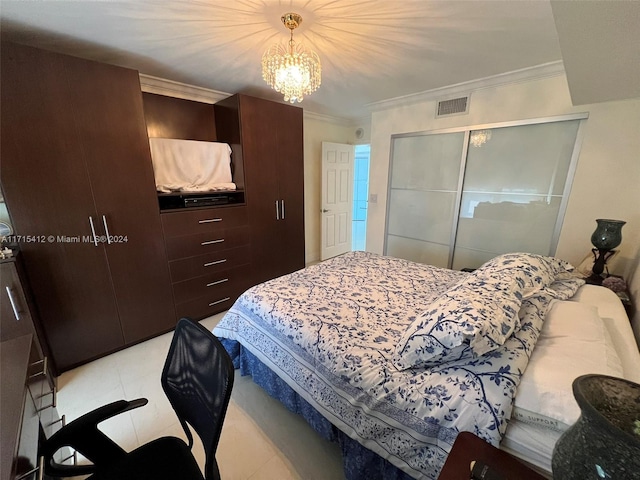 bedroom featuring a notable chandelier, crown molding, and a closet