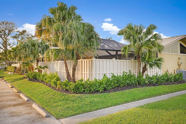 view of side of home with a lanai and central AC unit