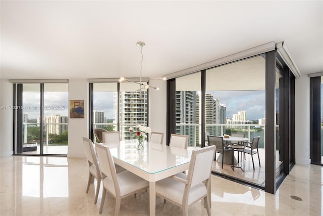 dining area featuring expansive windows and a notable chandelier