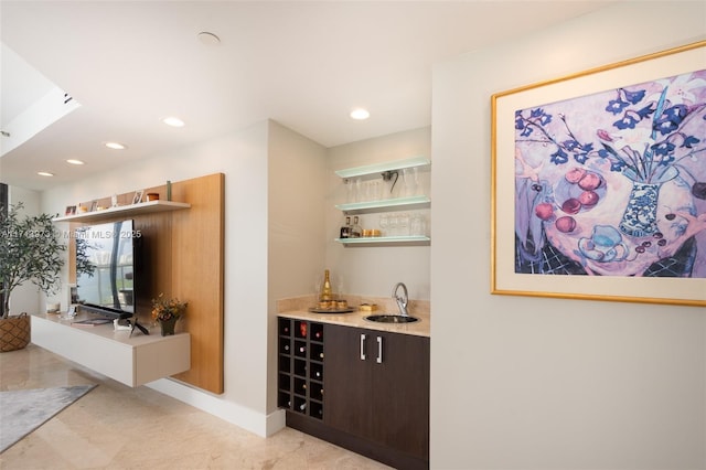 bar featuring sink and dark brown cabinets