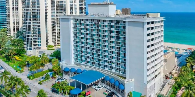 view of property featuring a view of the beach and a water view