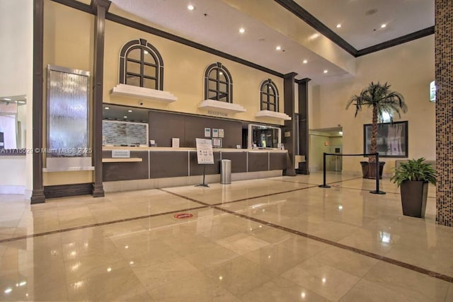 19201 Collins Ave Unit 1017, Sunny Isles Beach, FL 33160 - community lobby featuring crown molding, a towering ceiling, and recessed lighting