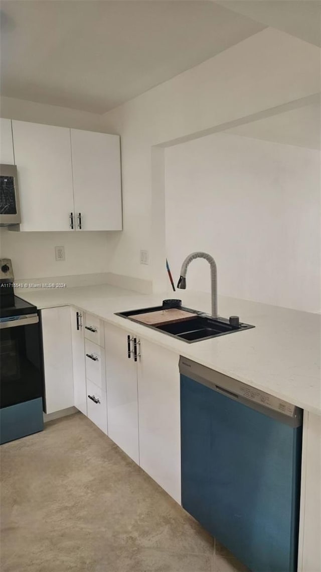 kitchen featuring white cabinets, stainless steel appliances, and sink