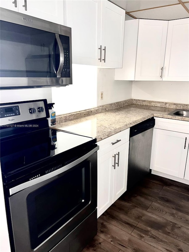 kitchen with appliances with stainless steel finishes and white cabinetry