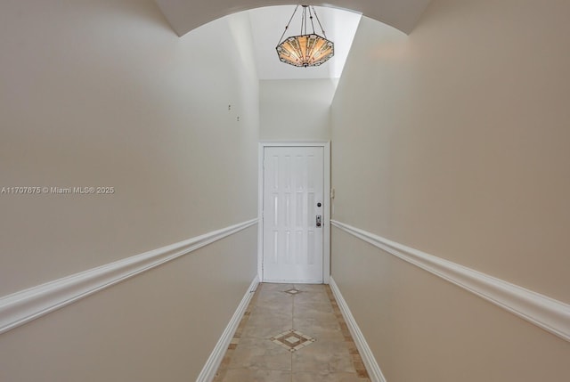 doorway to outside with light tile patterned floors