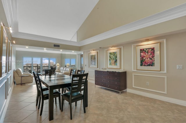 tiled dining space featuring high vaulted ceiling and ornamental molding