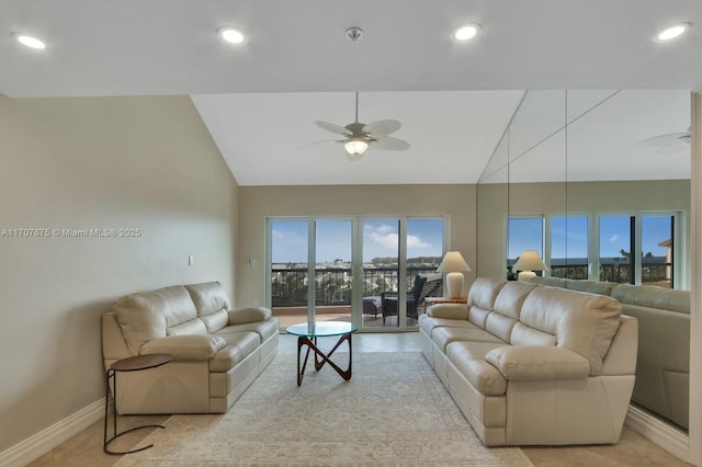 tiled living room with ceiling fan and lofted ceiling