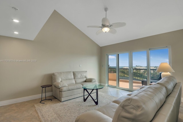 tiled living room with ceiling fan and high vaulted ceiling