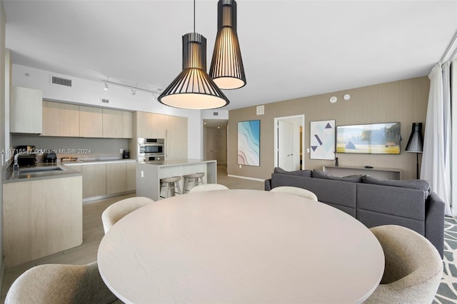 dining area with sink and light hardwood / wood-style flooring