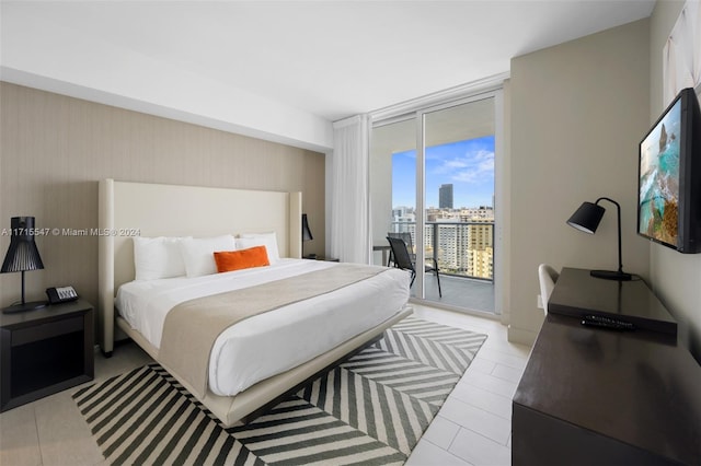 bedroom featuring a wall of windows and access to outside