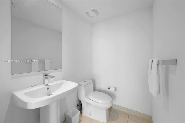 bathroom with tile patterned flooring, toilet, and sink