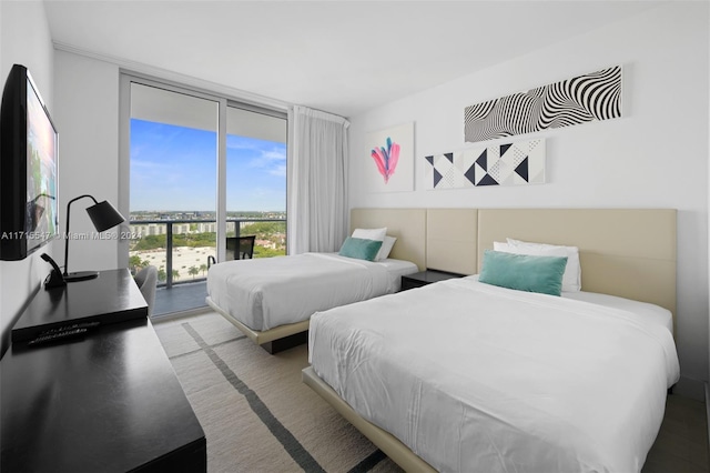 bedroom featuring access to outside and floor to ceiling windows