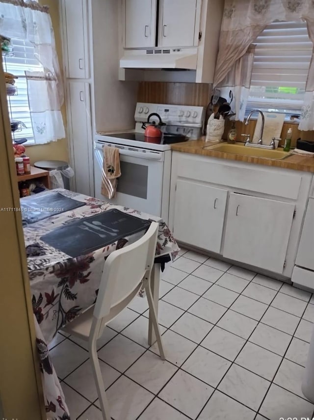 kitchen with sink, white cabinetry, white electric stove, and light tile patterned floors