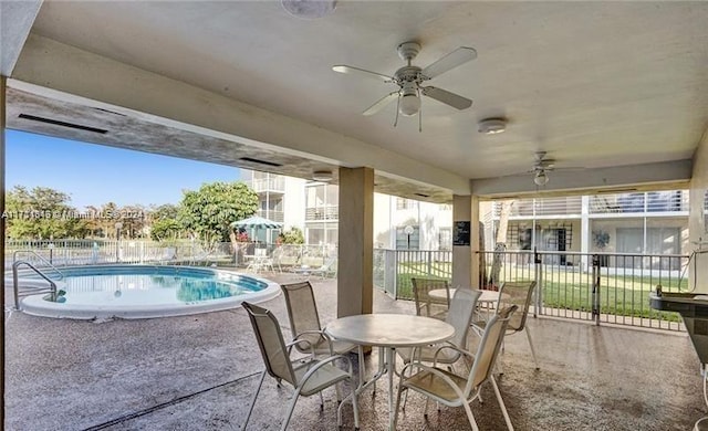 view of patio with a fenced in pool and ceiling fan