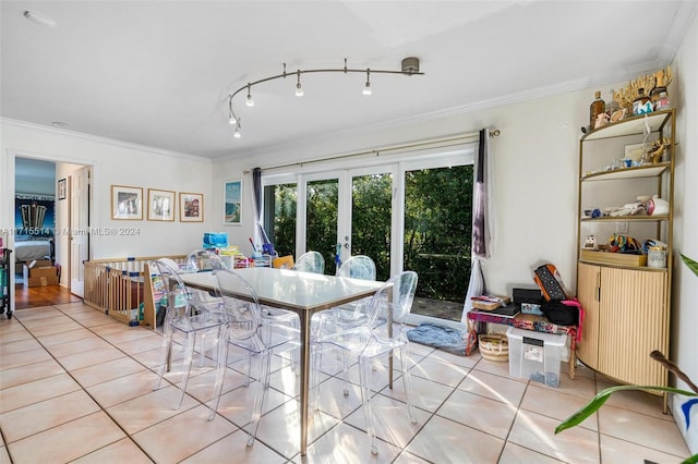 dining area featuring crown molding, french doors, and light tile patterned flooring