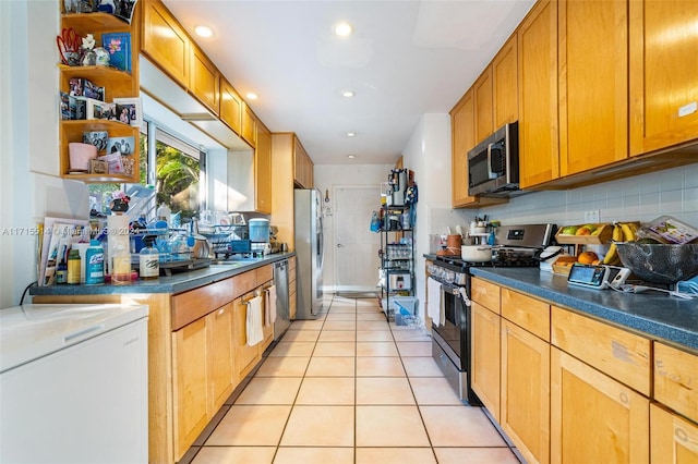 kitchen with decorative backsplash, appliances with stainless steel finishes, and light tile patterned flooring