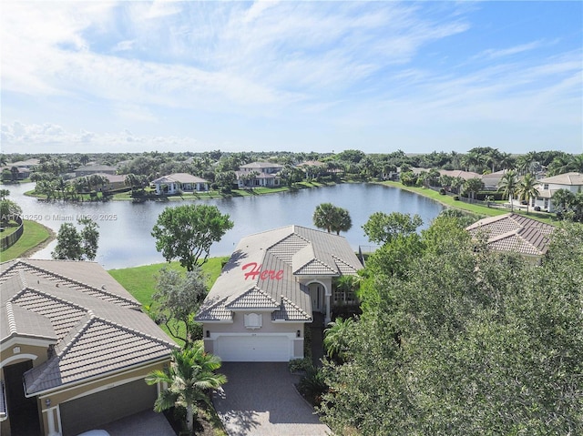 birds eye view of property with a water view