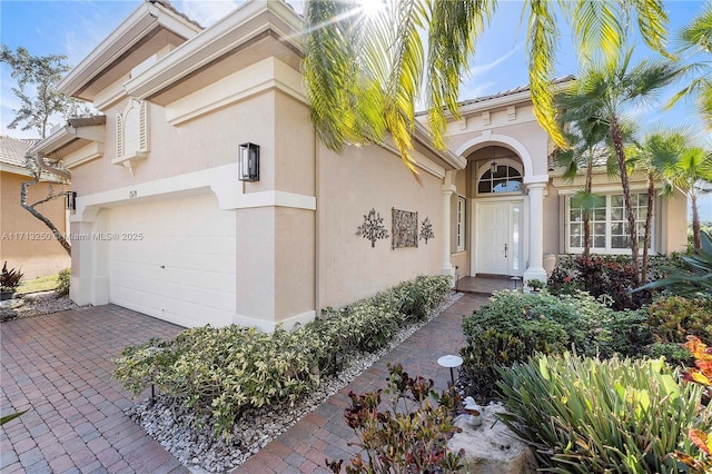 view of exterior entry featuring a garage