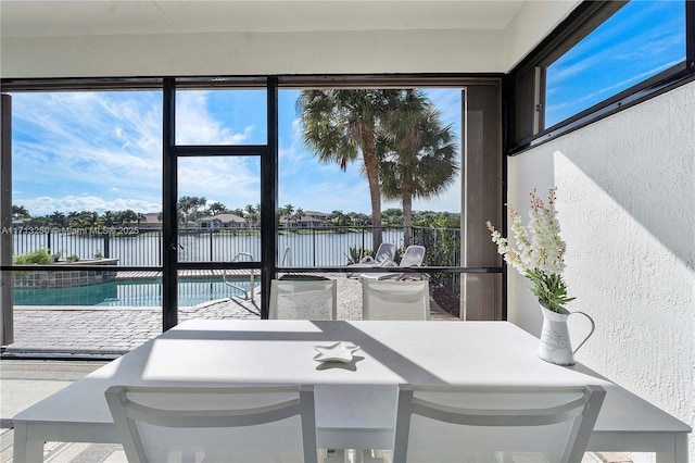 sunroom / solarium with a water view