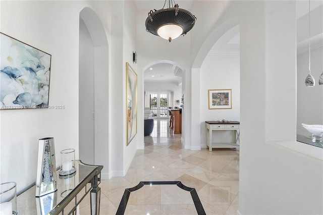 corridor with ornamental molding and french doors