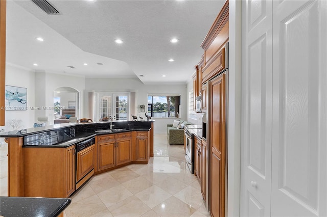 kitchen featuring stainless steel range with electric cooktop, sink, ornamental molding, paneled dishwasher, and a center island with sink