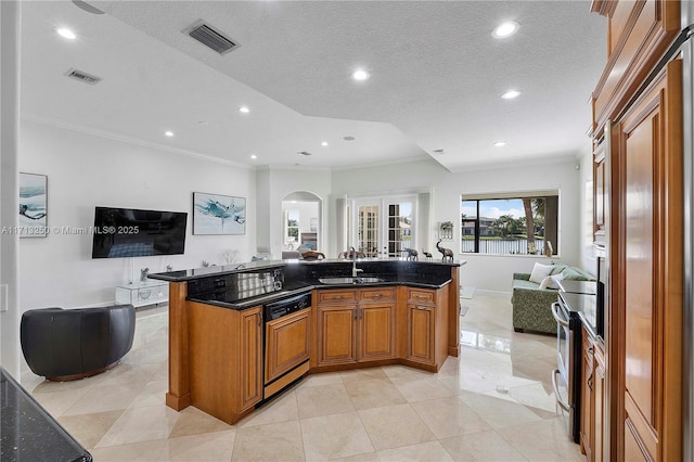 kitchen featuring a large island with sink, sink, and ornamental molding