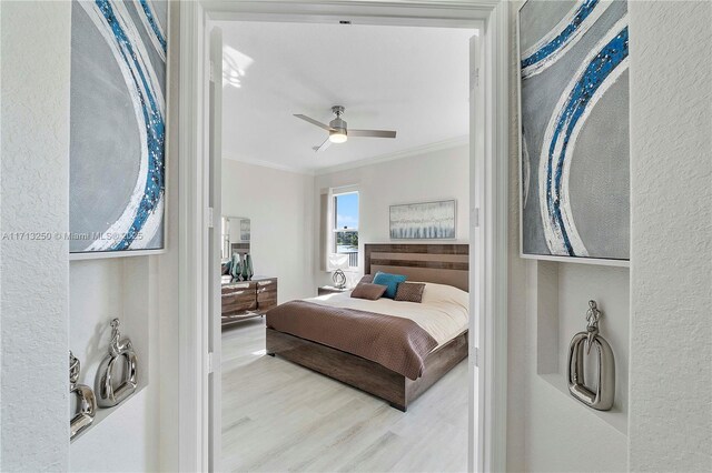 bedroom featuring ceiling fan, ornamental molding, and wood-type flooring