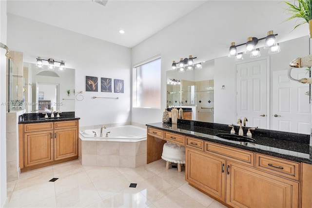 bathroom featuring plus walk in shower, tile patterned floors, and vanity