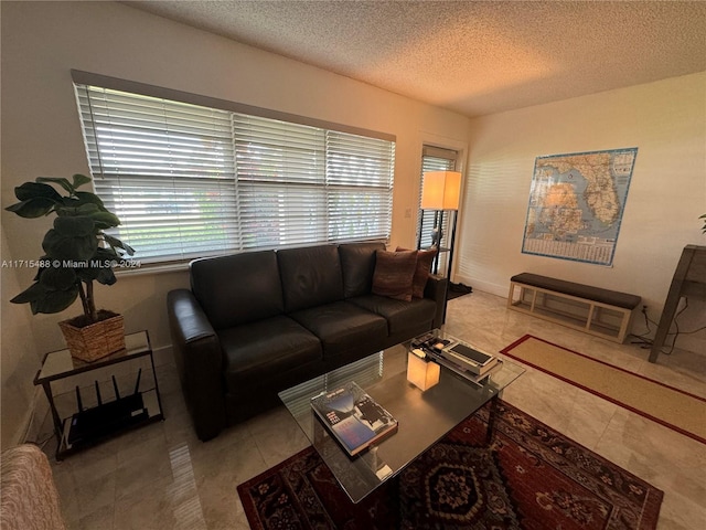 living room with light tile patterned floors and a textured ceiling