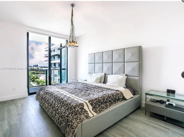 bedroom featuring hardwood / wood-style floors and floor to ceiling windows