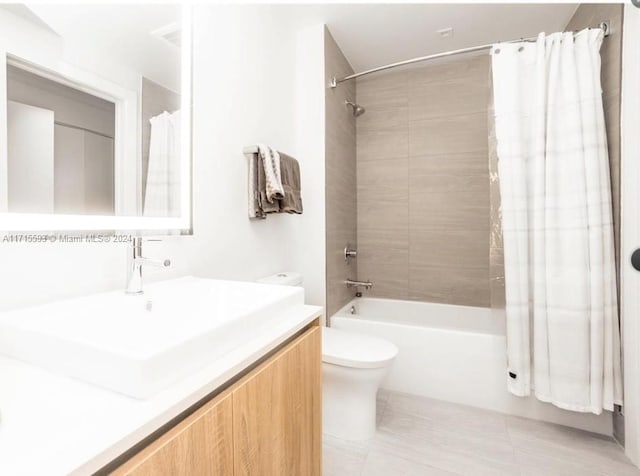 full bathroom featuring tile patterned floors, vanity, shower / bathtub combination with curtain, and toilet