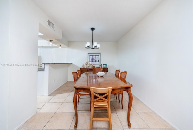 tiled dining area featuring a notable chandelier