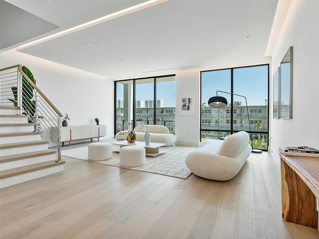 living room featuring light hardwood / wood-style flooring and a wall of windows