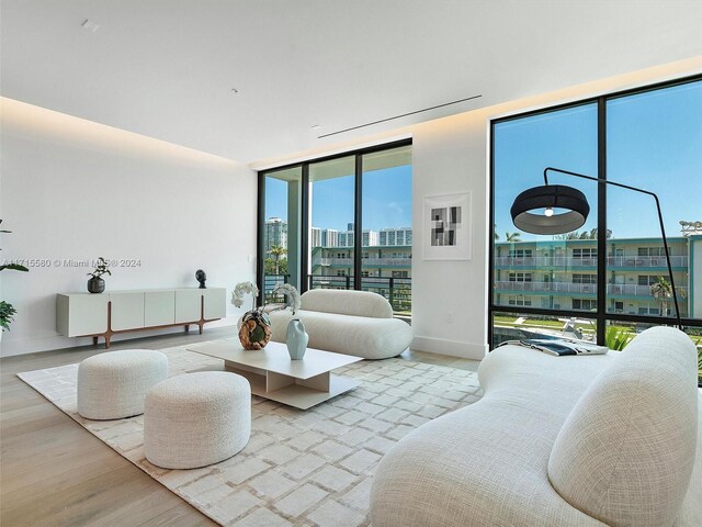 bedroom with light hardwood / wood-style floors and expansive windows