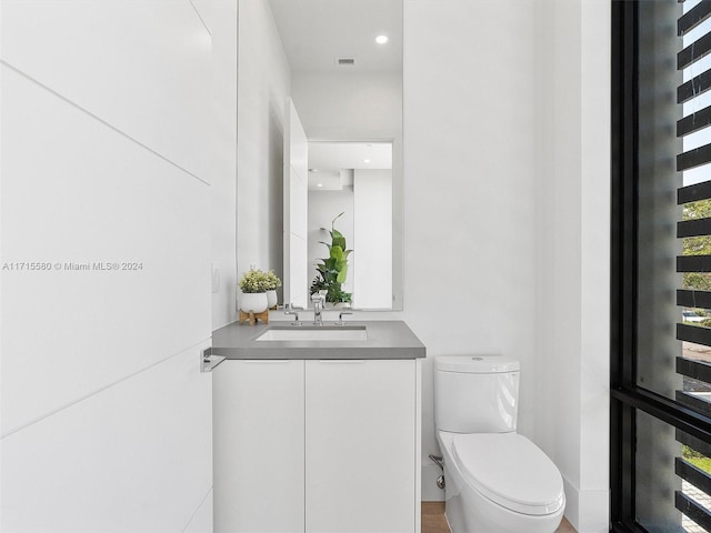 bathroom with vanity and toilet