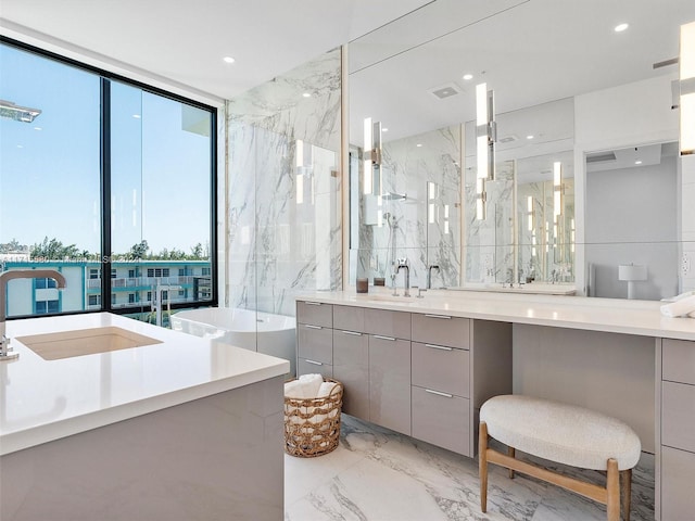 bathroom with expansive windows, a shower, and vanity