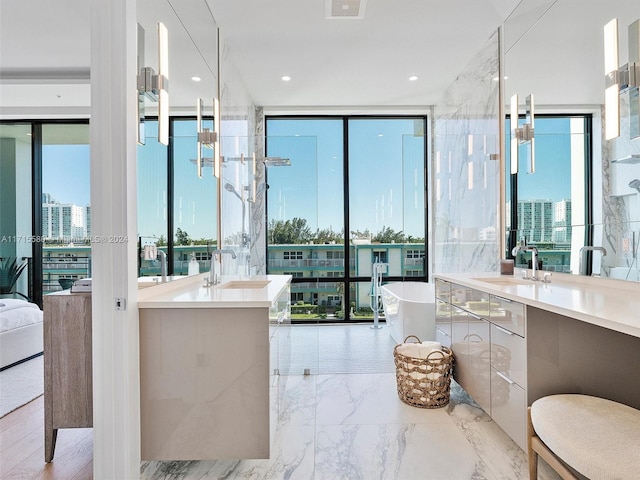 bathroom featuring a wealth of natural light, vanity, and floor to ceiling windows