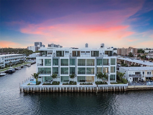 outdoor building at dusk featuring a water view