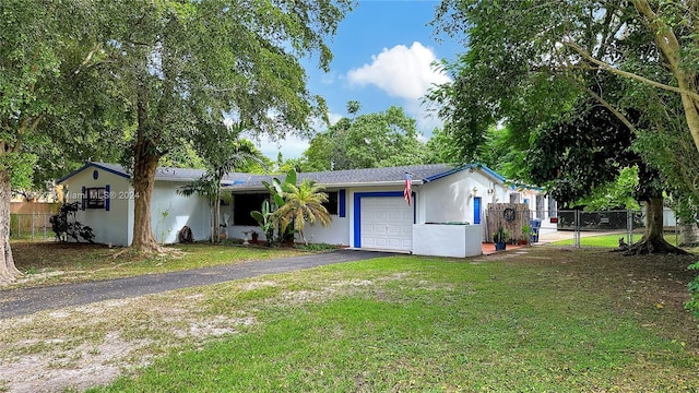 ranch-style house with a front yard and a garage