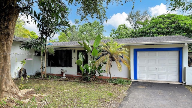 single story home featuring a garage