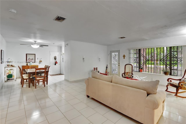 living room featuring ceiling fan and light tile patterned floors